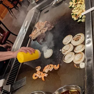 a person cooking food on a grill