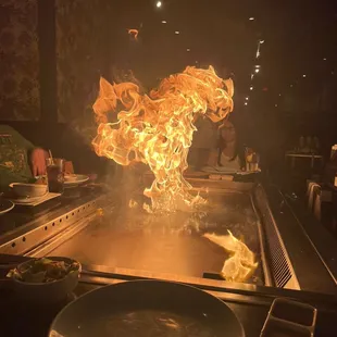a large flame coming out of a grill