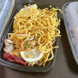 a plate of noodles and chicken