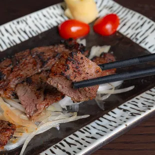 a plate of food with chopsticks