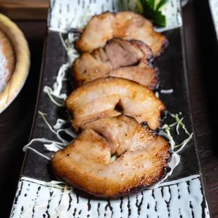 a plate of sliced pork