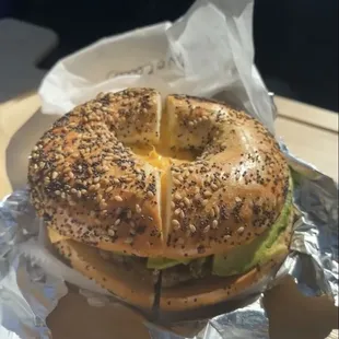 Sausage egg and cheese bagel with avocado