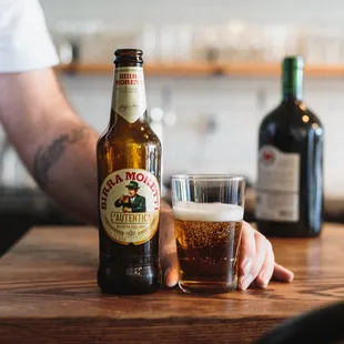 a man holding a glass of beer