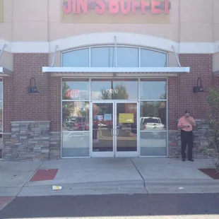 a man standing in front of a restaurant
