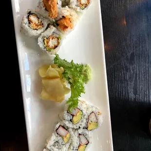 a plate of sushi and chopsticks