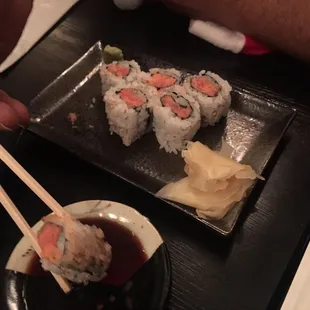 a plate of sushi and chopsticks