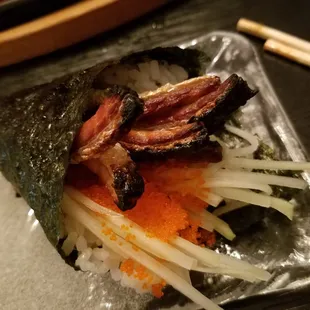 Crispy salmon skin and tobiko hand roll