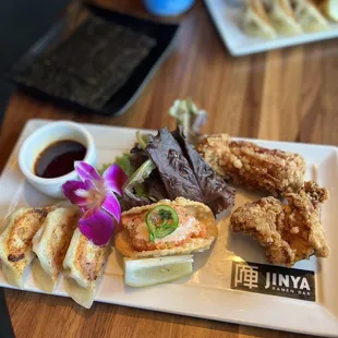 Appetizer sampler of gyoza, ahi taco, and karaage chicken