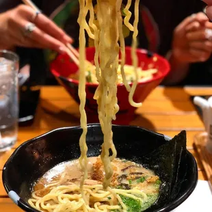 a bowl of ramen with chopsticks