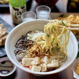 a bowl of ramen with chopsticks