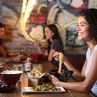 a woman eating a meal with friends
