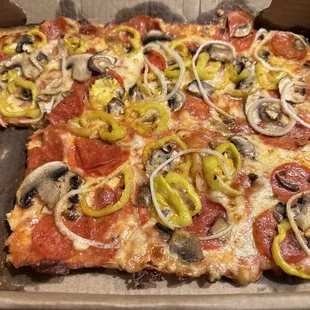 Pizza with pepperoni mushrooms onions and hot peppers