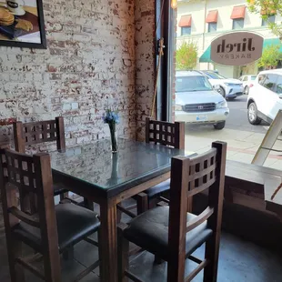 a table and chairs in front of a window