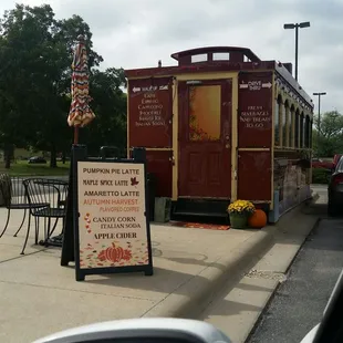 a red caboose on the side of the road