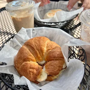 a croissant sandwich and coffee
