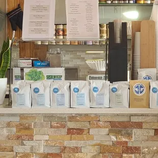 a counter with coffee bags on it
