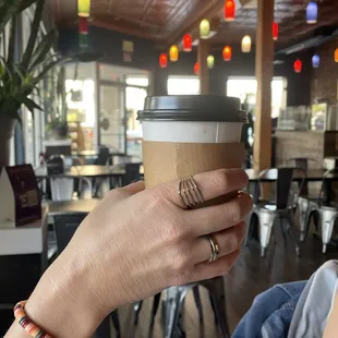 a woman holding a cup of coffee