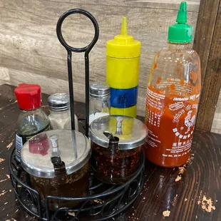 They kept condiments from previous owner. These glass containers are 花椒油 pepper oil and 辣椒油 toasted pepper oil.