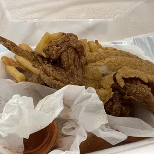 a basket of fried fish and fries