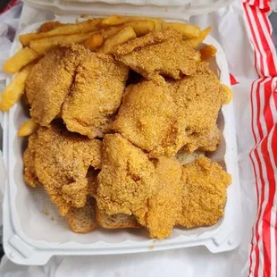 two trays of fried chicken and french fries