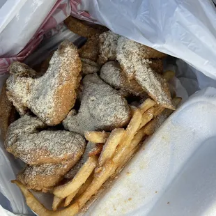 a bag of fried fish and chips