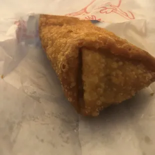 a close up of a pastry on a piece of wax paper