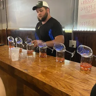 a man pouring a drink at a bar