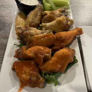 Hot Buffalo style and garlic/parm chicken wings with a side if celery and ranch