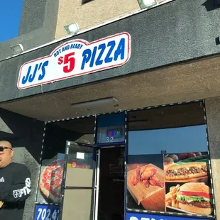 a man standing in front of a restaurant