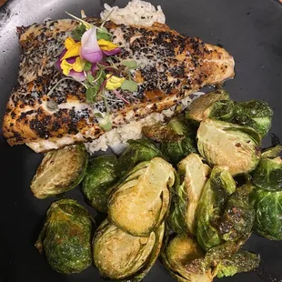 WALLEYE FILLET pepita and guajillo coated, lemon caper buerre blanc sauce with brussels and vegetable rice.