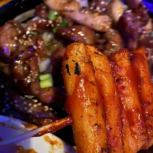 Spicy rice cake skewer and charbroiled pork original.