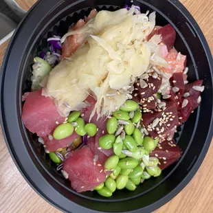 Build Your Own Bowl with 2 Scoops of Protein. Visible is tuna, salmon, cucumber, ginger, edamame, beets, and sesame seeds.
