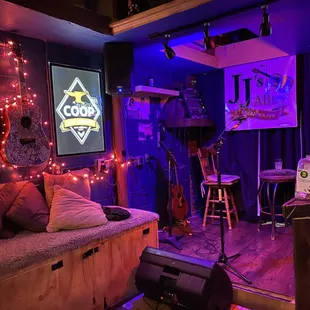 a living room with a couch and a guitar