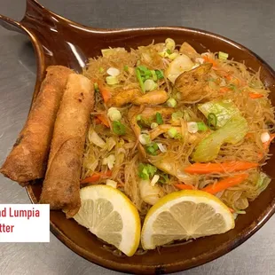 a plate of food with lemon wedges