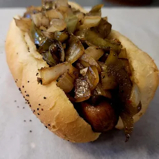 a hot dog with onions and peppers