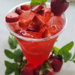 a drink with strawberries and mint