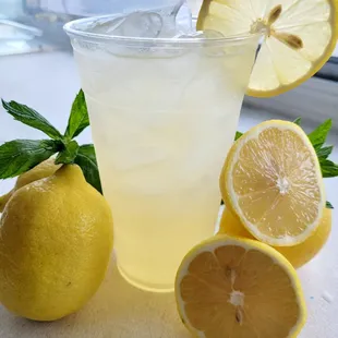 a glass of lemonade and lemons
