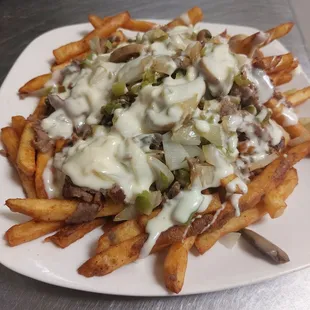 a plate of french fries topped with cheese