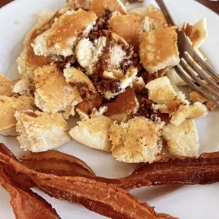 Chocolate chip pancakes with a side of perfectly cooked bacon