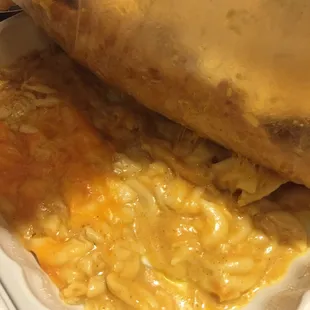Man n cheese stuck on the bottom and to the paper under the fish