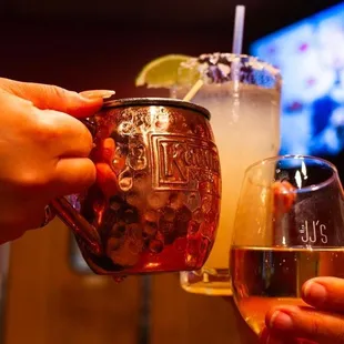 two people toasting with drinks