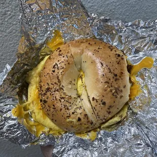 Egg, cheddar cheese, and bacon on an everything bagel