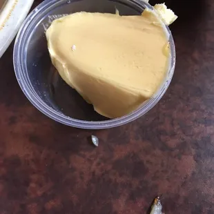 a piece of butter in a plastic container