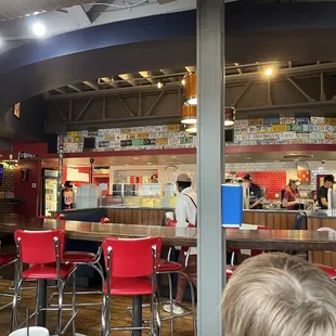 Dining room looking toward the counter and kitchen. Hot food comes out and is "dressed"  at the counter and delivered to the table.