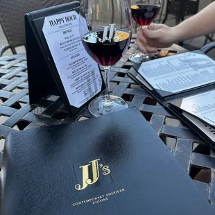 a menu and a glass of wine