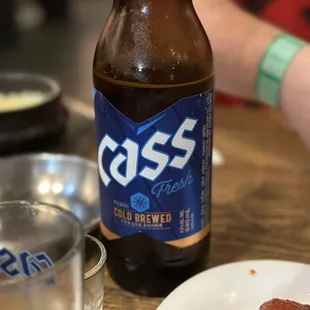 a plate of food and a bottle of beer