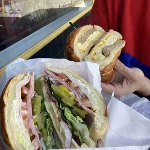 a person holding a sandwich in a wrapper