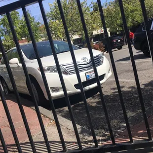 a car parked behind a fence