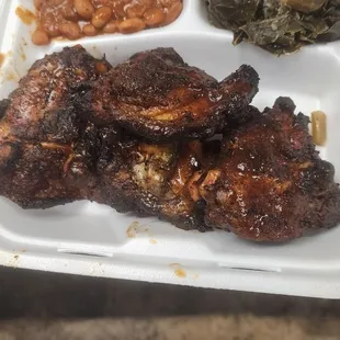 ribs, beans, and greens in a styrofoam container