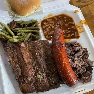 &quot; Straddle the fence&quot; - 3 meats and 2 sides. We chose ribs, brisket and hot link with ranch beans and green beans with potatoes